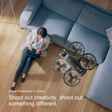 D2 drone flying indoors next to a sofa with full propeller guards
